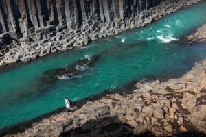 Turquoise river water and basalt rock formations at Stuðlagil Canyon
