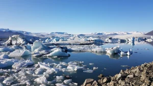 Icebergs and still water seen from the shore of Jökulsárlón