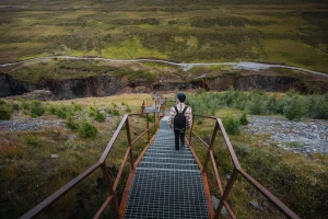 A visitor walking down the staircase to the west-side canyon viewpoint