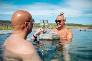 Two visitors relaxing in a geothermal pool at Vök Baths