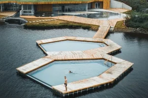 Floating geothermal pools beside the shore at Vök Baths